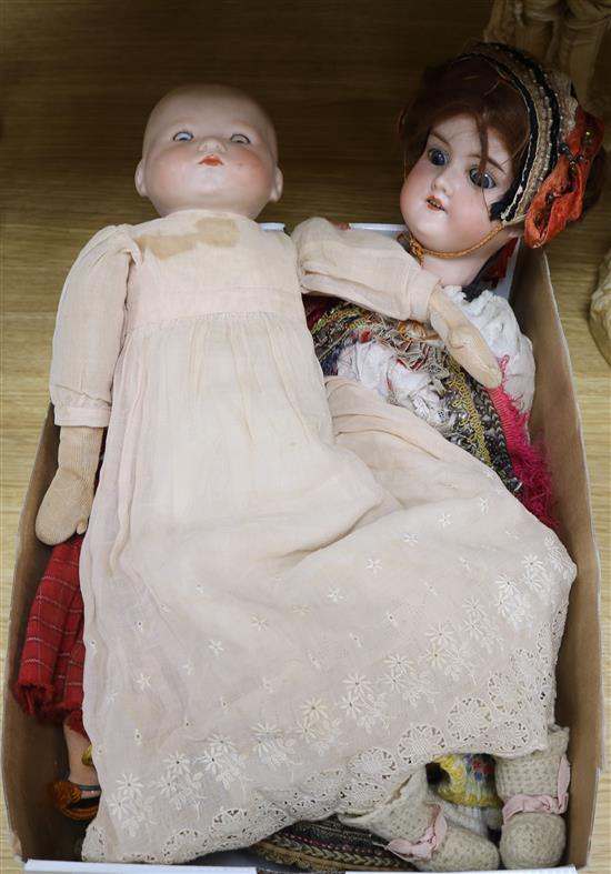 Three bisque headed dolls and a miniature doll